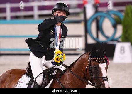 Tokyo, Japan. 02nd Aug, 2021. Equestrian Sport/Eventing: Olympics, Individual, Show Jumping, Final, Award Ceremony, at the Baji Koen Equestrian Park. Gold medallist Julia Krajewski from Germany rides a lap of honour on Amande de B`Neville and distributes air kisses to the spectators. Credit: Friso Gentsch/dpa/Alamy Live News Stock Photo